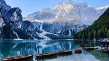 Scenic Shot Of Boats On Lake Braies And The Dolomite Mountains In Prags, South Tyrol, Italy