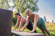 Caucasian plus size women in sportive clothes making plank together at the summer park
