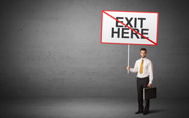 business person holding a traffic sign