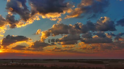 Wall Mural - Aerial view of spectacular sunset, slow panning across panoramic sky.
