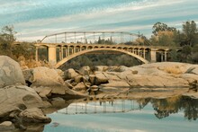 Reflection Of The Rainbow Bridge In Lake Natoma In Folsom, California