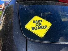 Baby On Board Warning Sign, Yellow Bumper Sticker On The Car Rear Door