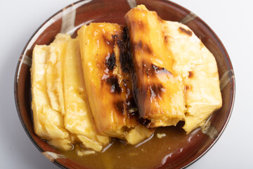 Wall Mural - Grilled cassava topped with sweet coconut milk. Thai dessert.