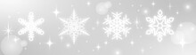 雪の結晶の形・キラキラした光・銀(シルバー)の背景・白い雪のクリスマス素材
