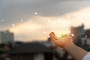 Wall Mural - hand showing business icons and globe at sunset. global business network in hand on a blurred backgr