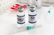 © angellodeco - Coronavirus vaccine and Flu vials vaccine for booster vaccination for new variants of Sars-cov-2 virus and Influenza A. Flu and Covid-19 vaccine ampoules for booster shot for Influenza virus and covid
