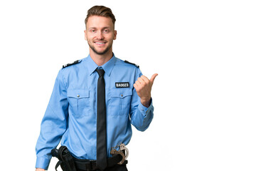 Wall Mural - Young police man over isolated background pointing to the side to present a product