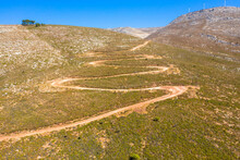 Spectacular Aerial View With Serpentine Off-road Track To Top Of Attavyros Mountain. Highest Mountain  In Rhodes Island, Greece. Tourism And Vacations Concept.