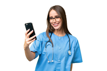 Young nurse caucasian woman over isolated background making a selfie