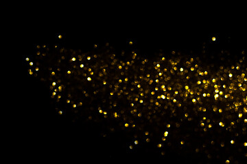 Wall Mural - a stripe of yellow defocused lights on a black background