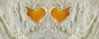 Close-up of two yolks on flour in the shape of a heart, love for baking