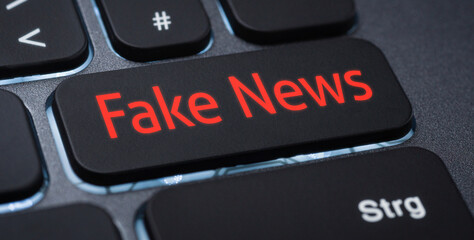 Wall Mural - illuminated keyboard with a labeled key - fake news