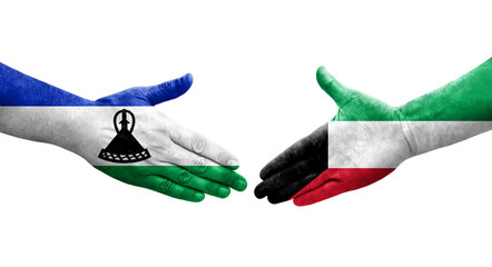 Handshake between Kuwait and Lesotho flags painted on hands, isolated transparent image.