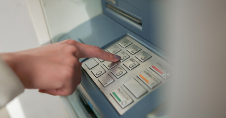 Wall Mural - close up young woman hand pressing on atm machine for unlock password or counting money , business concept	
