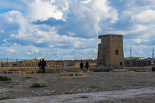 The Round Stone Slabs Covering Grain Pits Called The Granaries At The Tip Of Valletta With A World War 2 Watchtower In The Background.