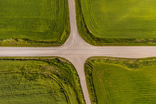 Aerial View Of A Crossroads On Country Gravel No Traffic Road Among Fields