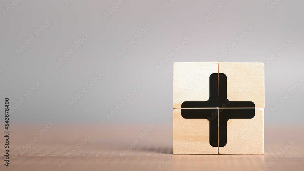 Plus sign in wooden cube block stack. added value, benefits, additional ...