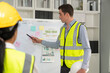 © Supachai - Engineer leader man presentation project and strategy plan to success on whiteboard with businessman corporate in meeting room at construction site office