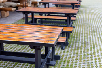 Many beautiful tables with benches outside