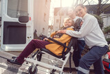 Fototapeta Przeznaczenie - Senior woman in wheelchair being picked up by team from transport service