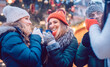 © Kzenon - Group of friends drinking mulled wine in the cold on a Christmas Market with fun and laughter