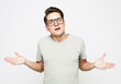 Shocked amazed surprised man wear eyeglasses standing keeping mouth open spreading hands over white background
