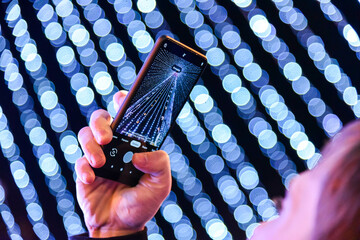 A man is photographing a Christmas tree on the phone  