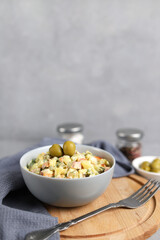 Wall Mural - Ensaladilla Rusa in a gray plate. Traditional Spanish food is tapas. Selective focus. Vertical photo, copy space