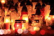 Yellow, orange and red grave candles placed in the cemetery, a symbol of memory