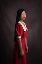 Portrait Of An Asian  Woman In Red And White Christmas Dress With Collar