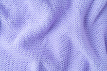 Close Up Background Of Knitted Wool Fabric Made Of Viscose Yarn. Bright Purple Color Crumpled Knitting Wool Knitwear Texture. Abstract Knitted Wrinkled Jersey Fabric Backdrop, Wallpaper
