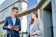 © Cavan Images - Business people dressed in formal wear meeting in front of the office