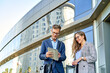 © Cavan Images - Business people dressed in formal wear meeting in front of the office