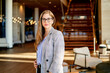 © Cavan Images - The smiling bank manager with a big smile in a big building