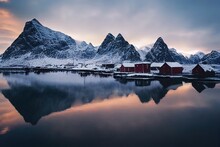 Wonderful Winter View On Snowcapped Mountains, Red Fishing Hut And Cloudy Sky With Reflection. Typical Nature Landscape Of Lofoten Islands. Norway. Travel Adventure And Freedom Concept.