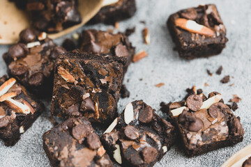 Homemade dark chocolate brownies topping with almonds slices and chocolate chips