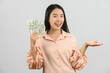 © Johnstocker - Portrait of a cheerful young woman holding money banknotes and celebrating isolated over white background