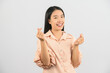 © Johnstocker - Portrait of Happy young asian woman in pink shirt doing shapes heart gesture isolated on white background