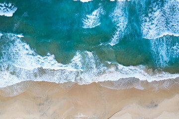  Aerial view of sea crashing waves White foaming waves on beach sand, Top view beach seascape view Nature sea ocean background