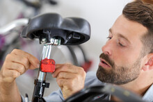 Close Up Of Man Adjusting Fixed Gear Bike Saddle High
