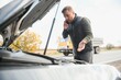 © Serhii - Man with broken car in the middle of the road.