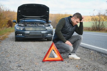 Wall Mural - Man with broken car in the middle of the road.