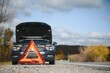 © Serhii - breakdown triangle stands near a broken car.