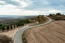 Spain, Catalonia, Les Garrigues, Aerial View Of Winding Country Road And Surrounding Landscape