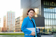 © Westend61 - Confident businesswoman with tablet PC standing in front of building