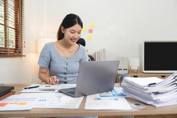 Wall Mural - Portrait accounting asian woman working for financial with paperwork using laptop computer and calculator.