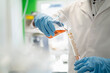 © Westend61 - Scientist with test tube doing thermolysis experiment in laboratory
