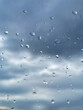 Rain drops on Window. Cloudy sky in the background. Stock Image.