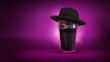 Gentleman. Glass of dark beer wearing black hat isolated over dark purple neon background. Concept of alcohol, drinks, holidays and festivals.