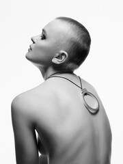 Wall Mural - beautiful woman with short haircut. back of naked bald girl. jewelry on spine